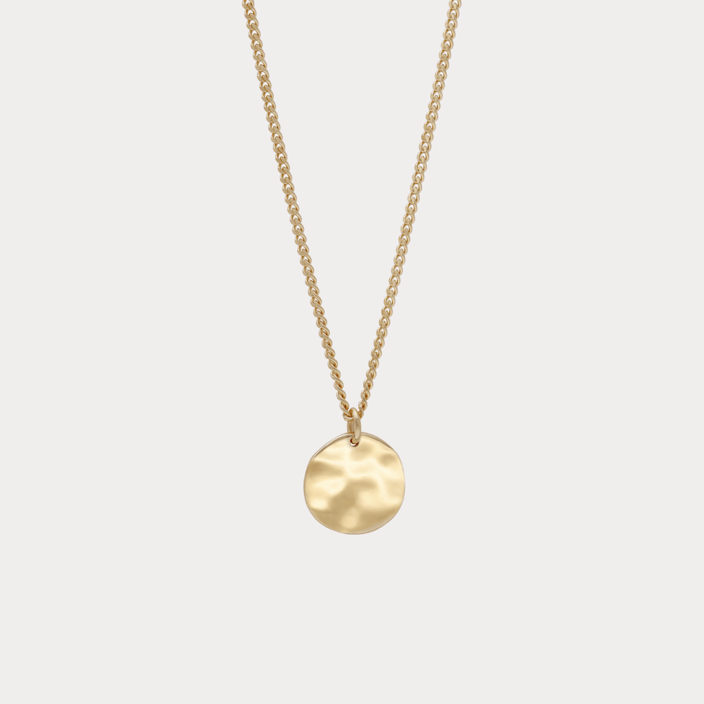 close up detail of front of gold pendant